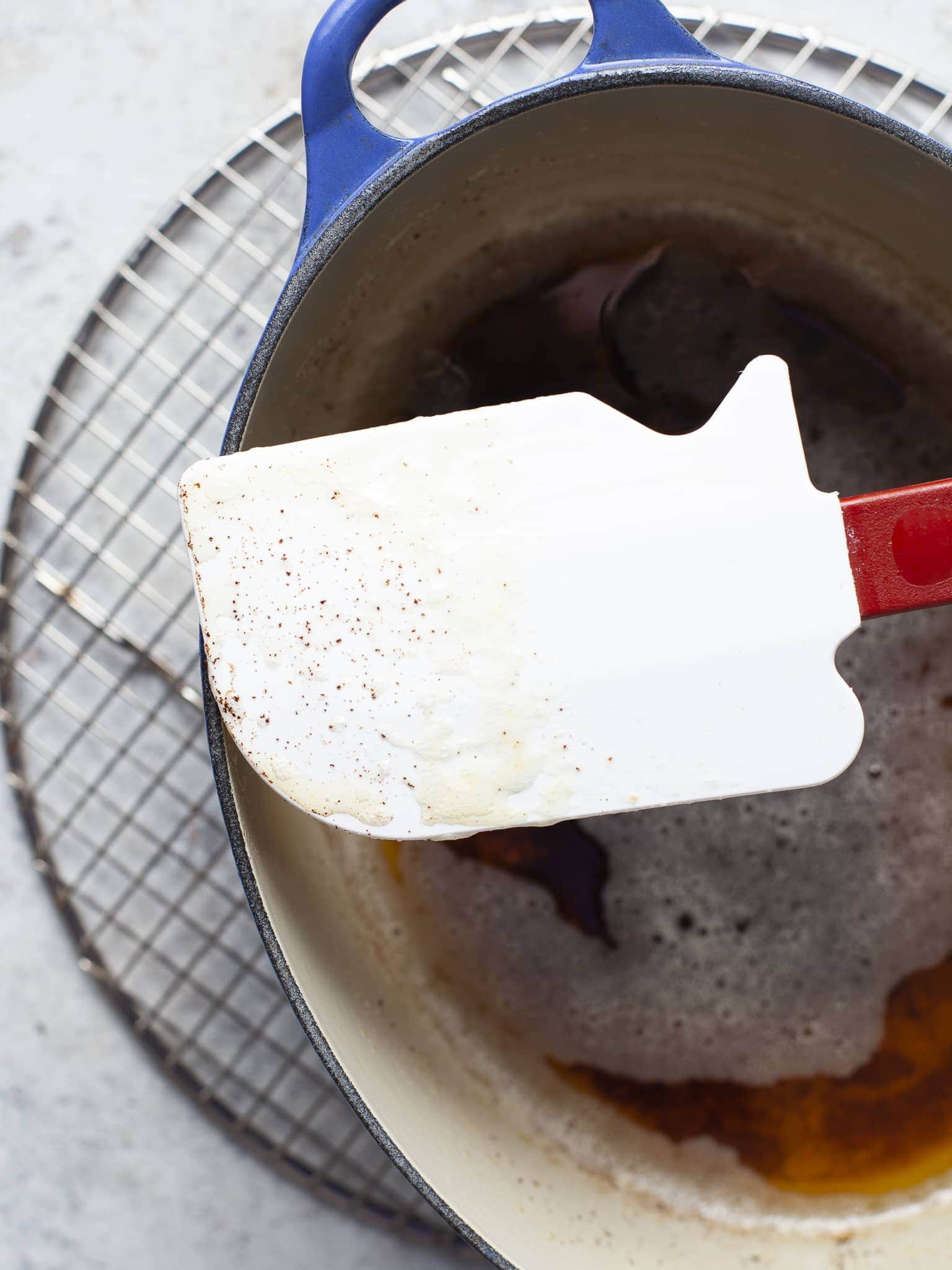 specs of browned butter on a spatula