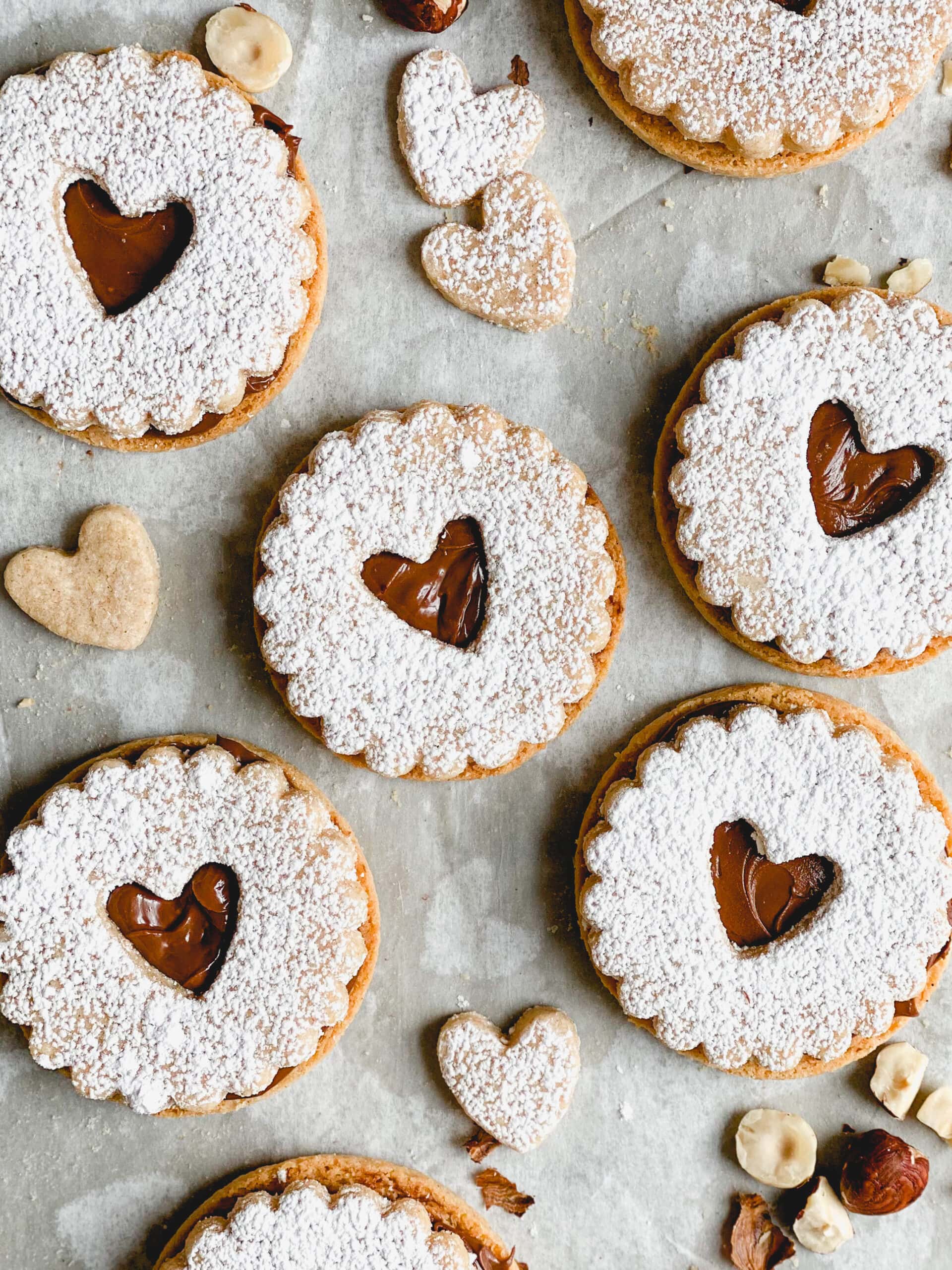 Linzer cookies with heart shaped centers. Filled with Nutella