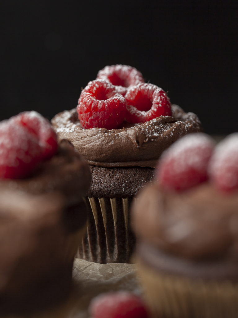 Dark Chocolate Cupcake with Raspberries and Powdered Sugar
