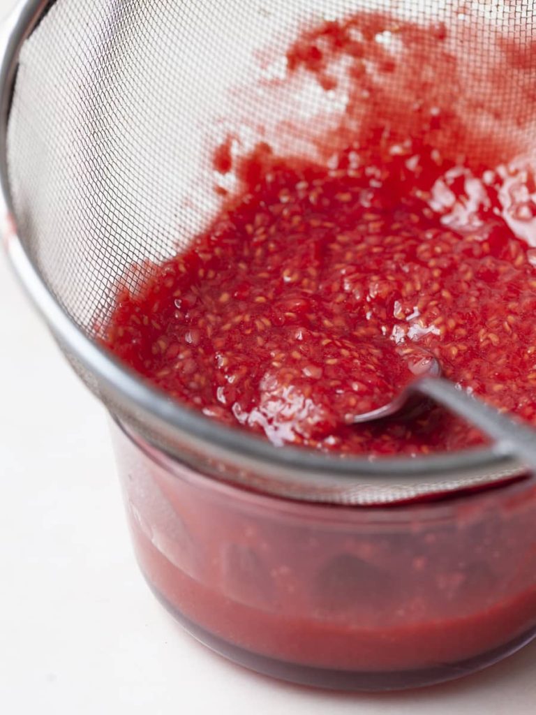 strained raspberries for raspberry sauce for cheesecake