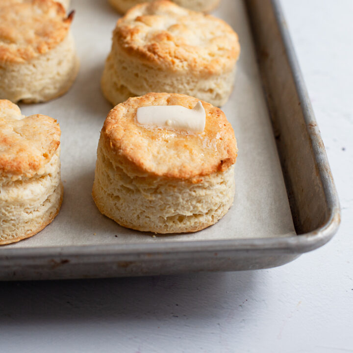 A gluten free flaky biscuit topped with butter