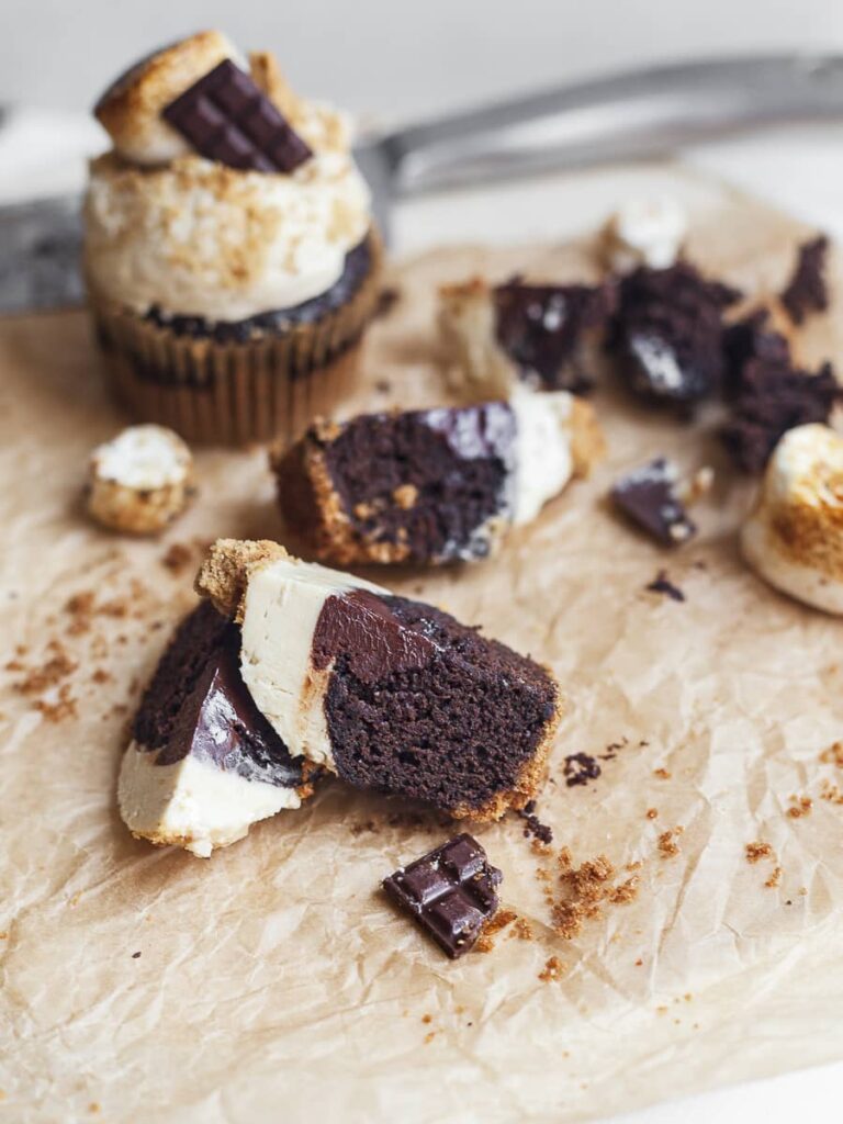 cut up gluten free s'mores cupcakes with ganache filling and toasted marshmallow frosting