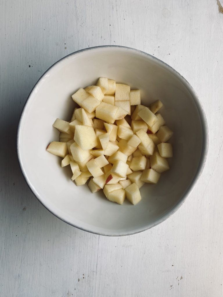 a bowl with diced apples to make caramel apple topping