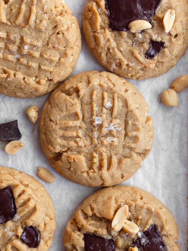 soft and chewy gluten free peanut butter cookie topped with hunks of dark chocolate, peanuts and seasalt
