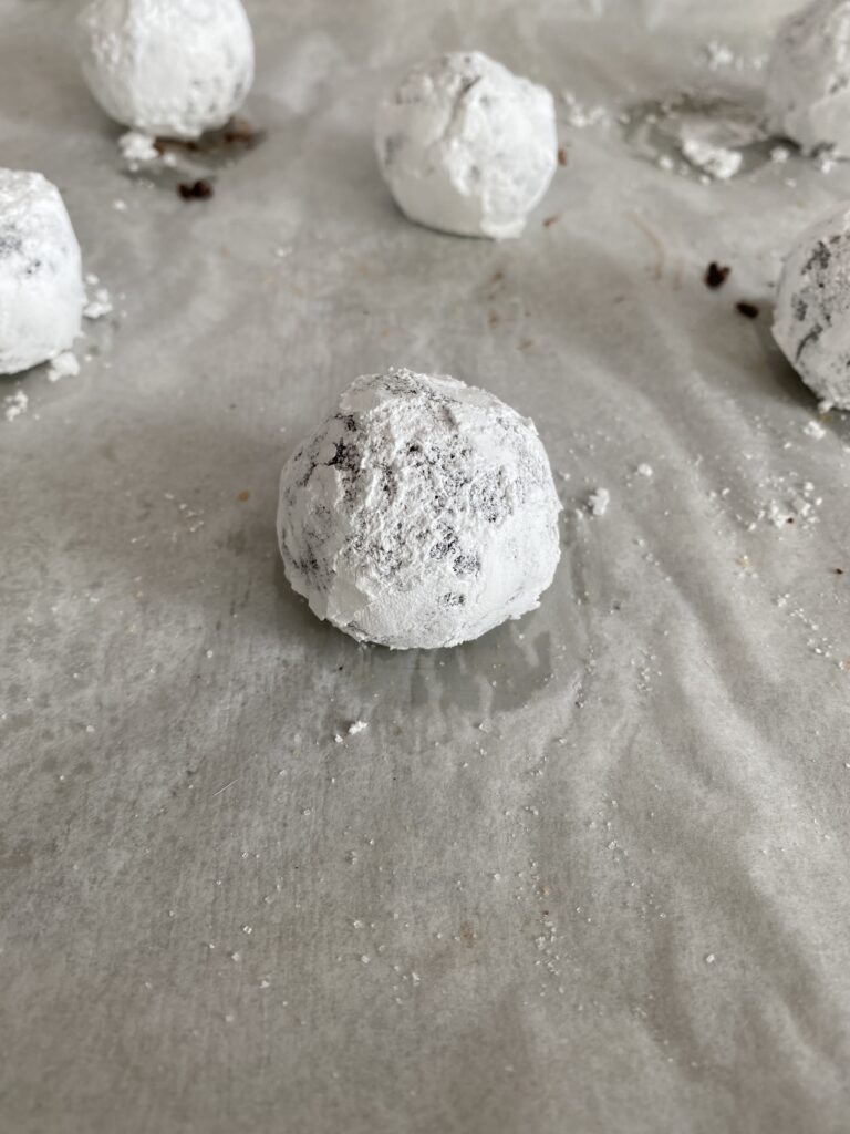 dough coated in sugar and powdered sugar before baking