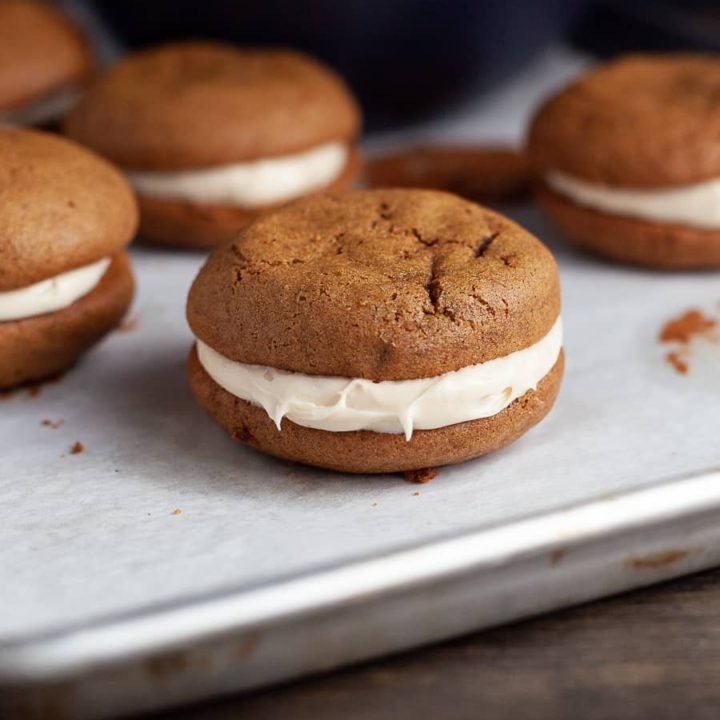 Gluten Free Gingerbread Whoopie Pies are two perfectly spiced, soft gingerbread cookies sandwiched together with a luscious brown sugar frosting.