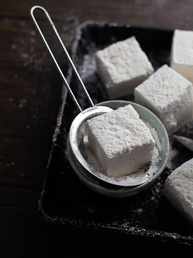 Nothing beats homemade Marshmallows - soft, fluffy pillows with a hint of vanilla and naturally gluten-free. They are definitely better than what you can buy at the store. Add homemade vanilla marshmallows to a cup of Hot Cocoa, dip them in chocolate and sprinkles, or eat them just as is. 