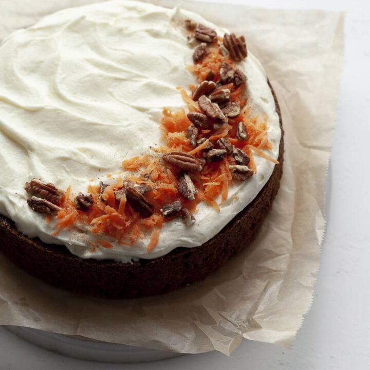 SIngle Layer Gluten Free Carrot Cake topped with cream cheese frosting, carrots and pecans