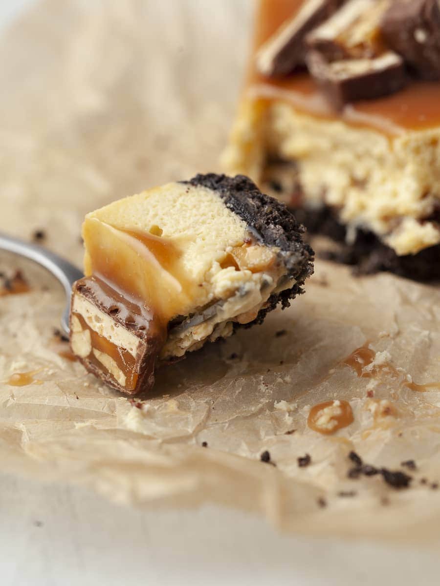 a bite of snickers cheesecake on a fork