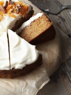 a slice of gluten free carrot snack cake topped with cream cheese frosting