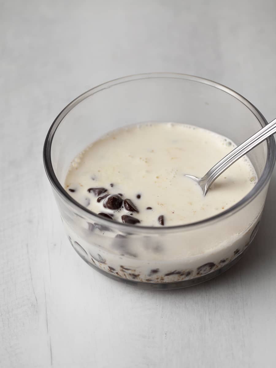 a bowl with chocolate chips and heavy cream to make chocolate ganache
