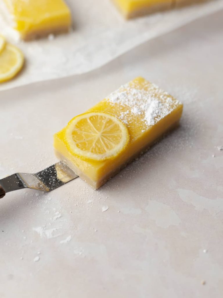 a slice of lemon bar with gluten free almond shortbread crust
