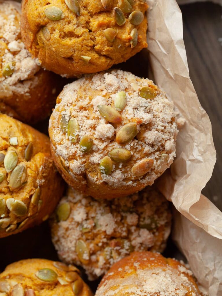 gluten free pumpkin muffins topped with brown sugar streusel and pumpkin seeds
