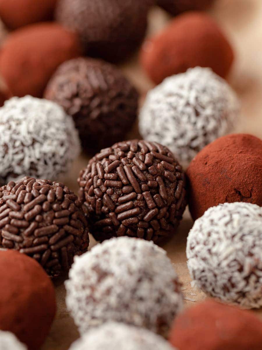 gluten free rum balls coated with coconut, cocoa powder and chocolate sprinkles