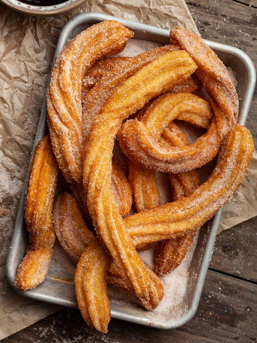 a tray with gluten free churros tossed in cinnamon sugar