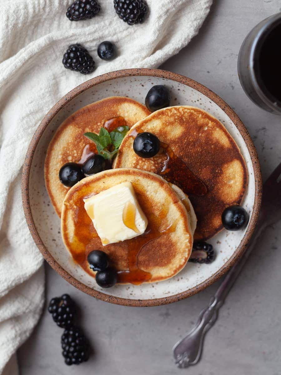 gluten free pancake recipe topped with fresh fruit and maple syrup