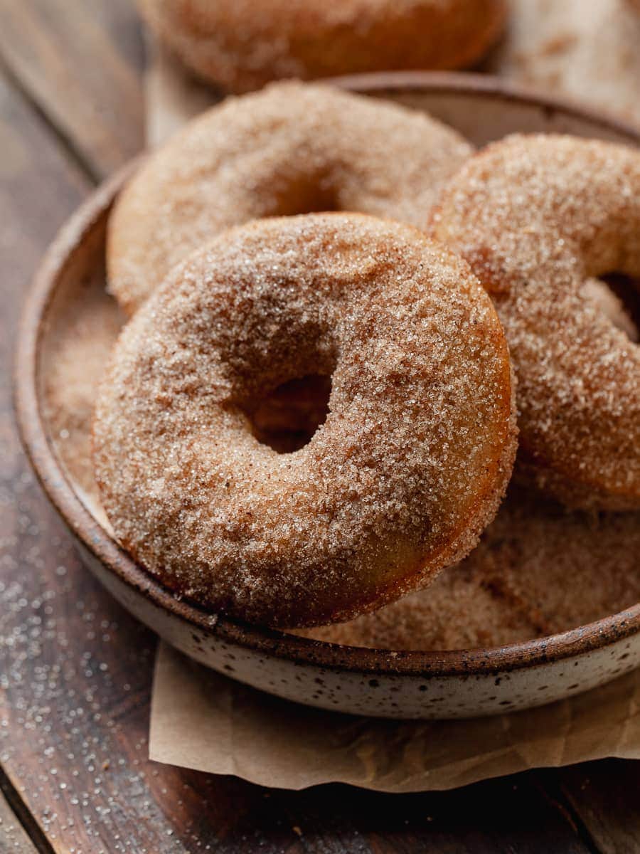 Apple Cider Donuts in a small plate on brown parchment paper