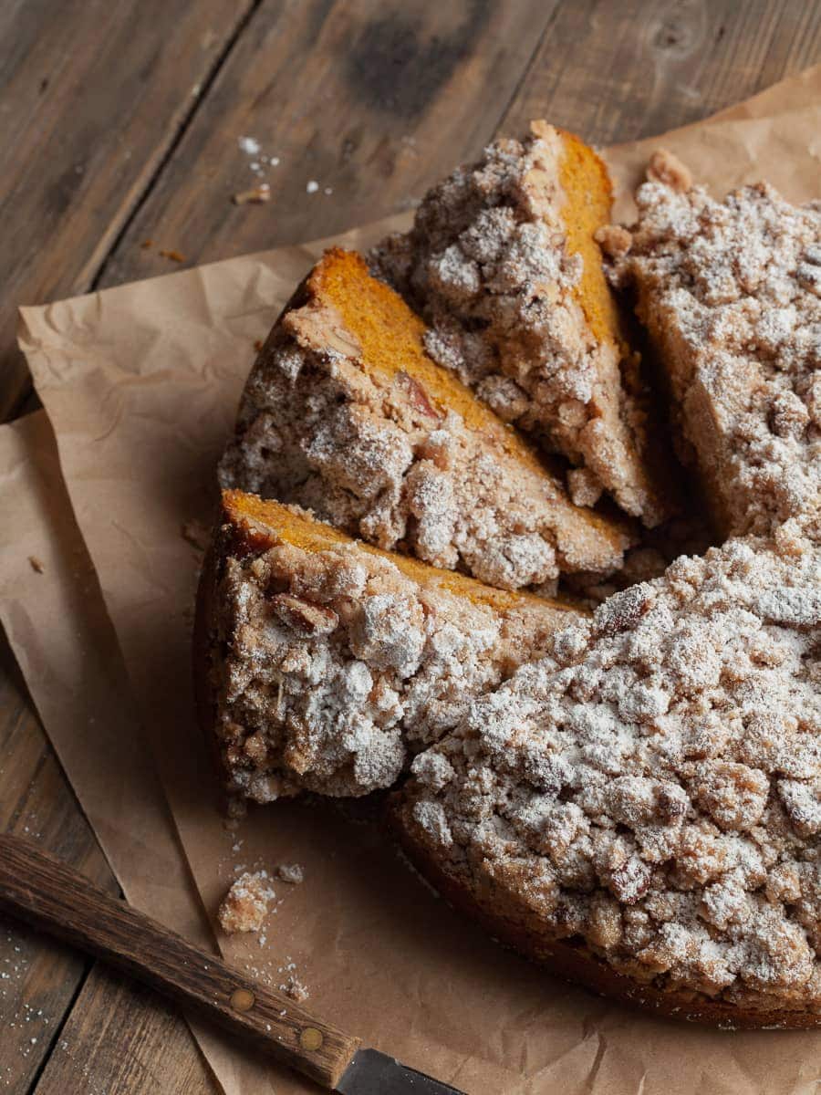 sliced Gluten Free Pumpkin Coffee Cake on a brown parchment paper