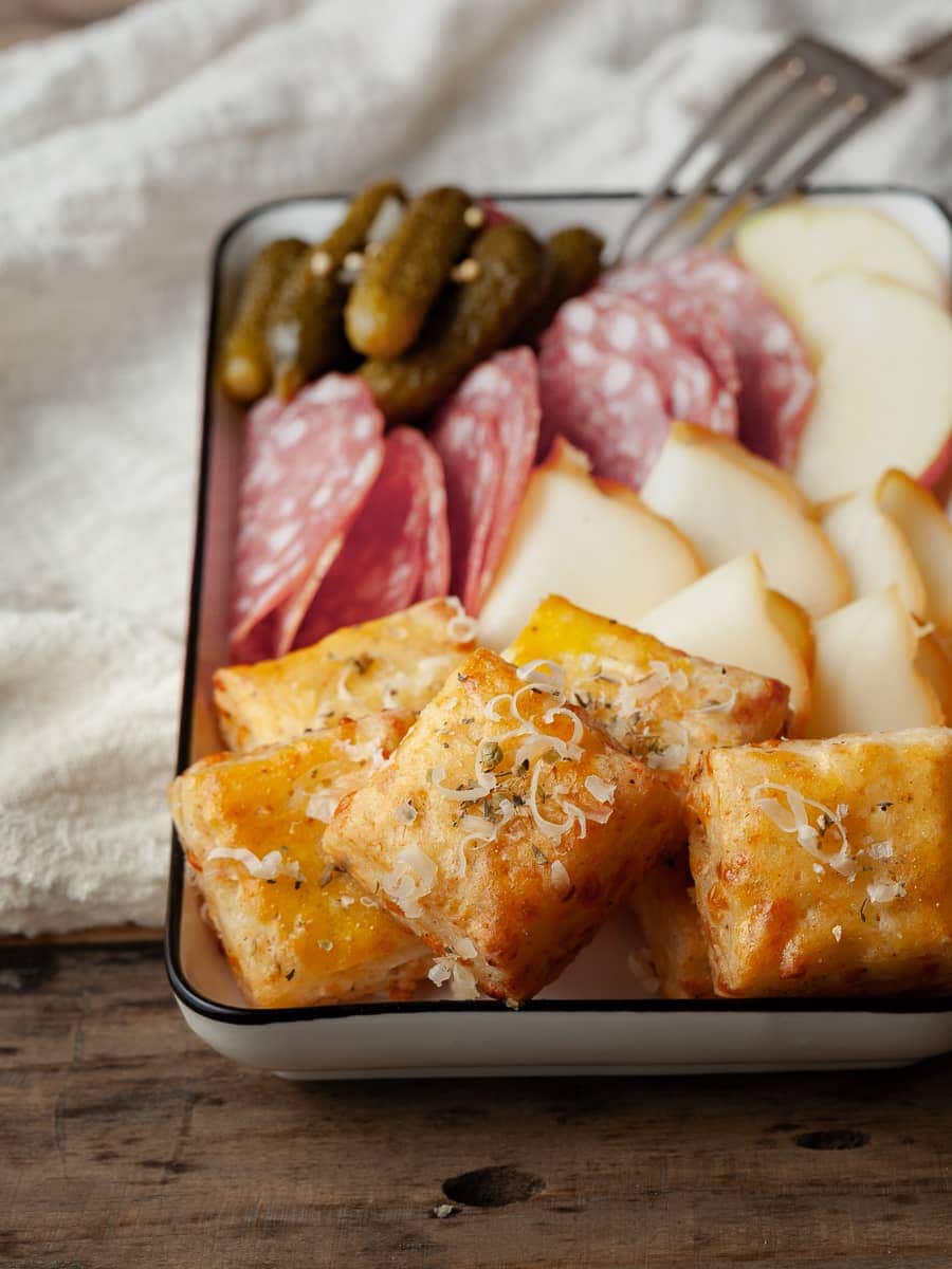 a gluten free charcutier board with gluten free cold cuts, cheese and homemade gluten free cheese crackers 