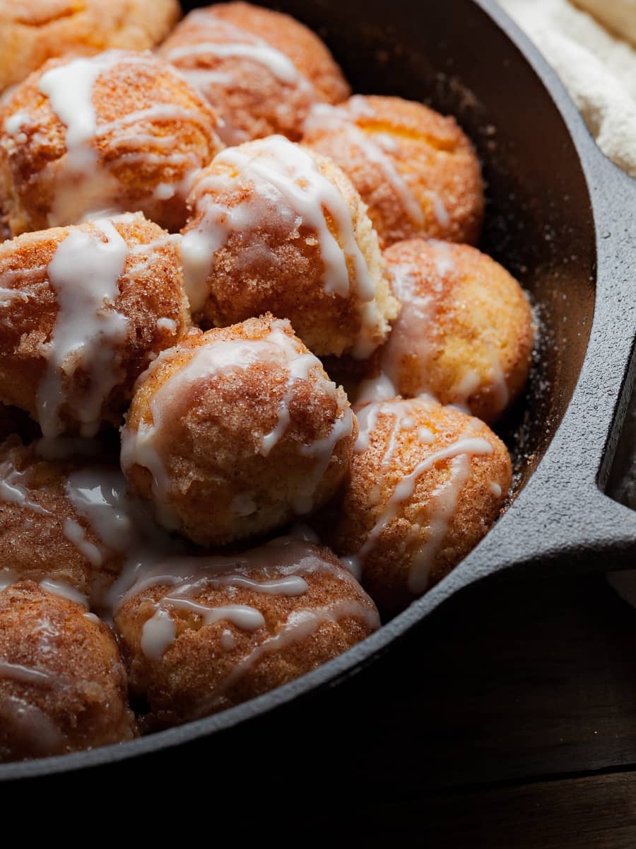 Gluten Free Monkey Bread baked in a skillet and drizzled with a sour cream glaze