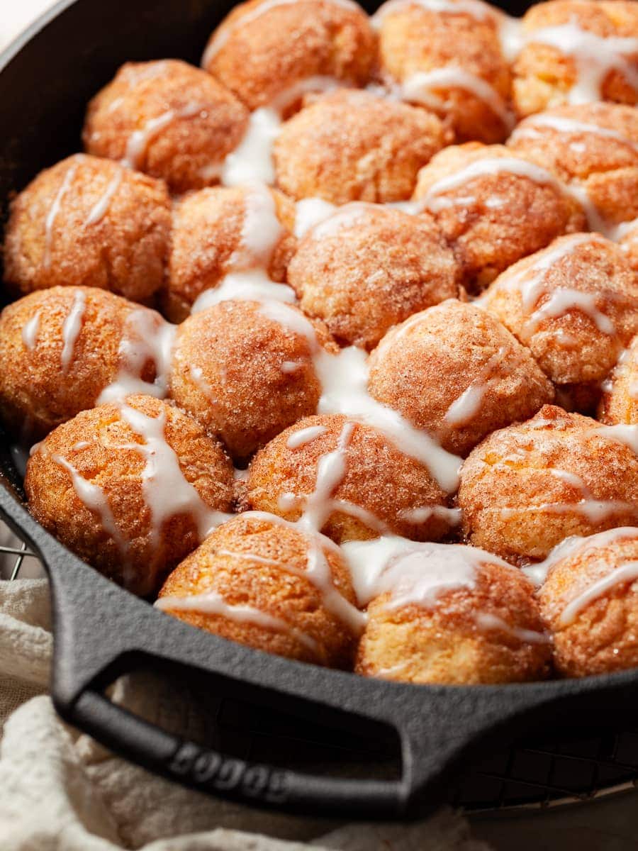 Gluten Free Monkey Bread baked in a skillet and drizzled with a sour cream glaze