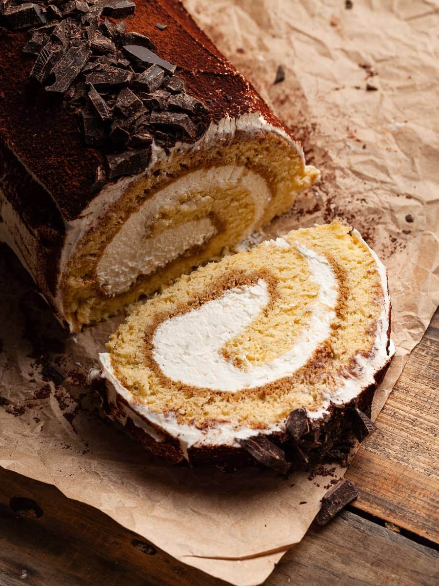 This Gluten Free Tiramisu Cake Roll is a combination of my two favorite desserts: Swiss Roll (Biskuitroulade) and the Italian dessert Tiramisu. A light and airy gluten-free sponge cake, drenched in a decadent coffee syrup, and generously filled with a luxuriously smooth mascarpone frosting. The result is a stunning dessert that is as delicious as it is eye-catching.