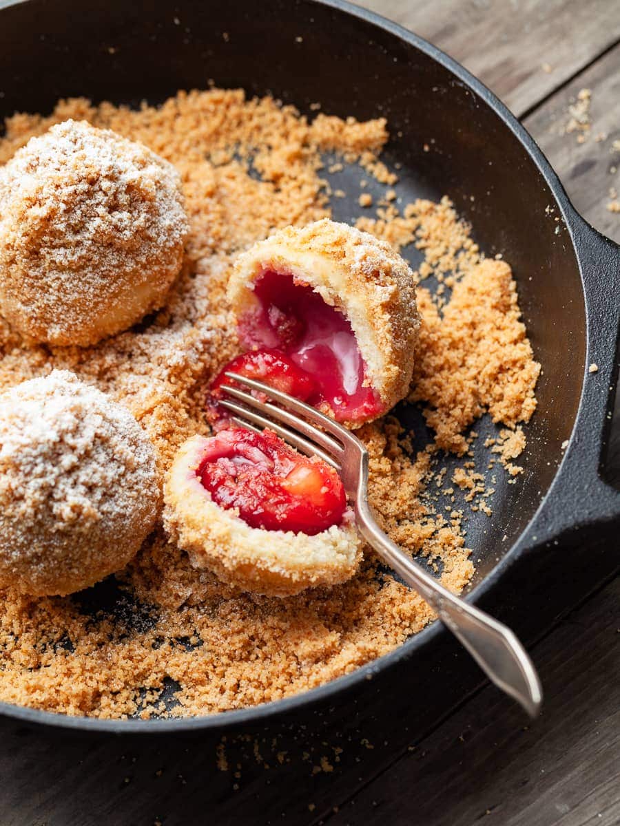 Gluten Free Zwetschgenknödel, Gluten Free Plum Dumplings in a cast iron pan coated with gluten free bread crumbs