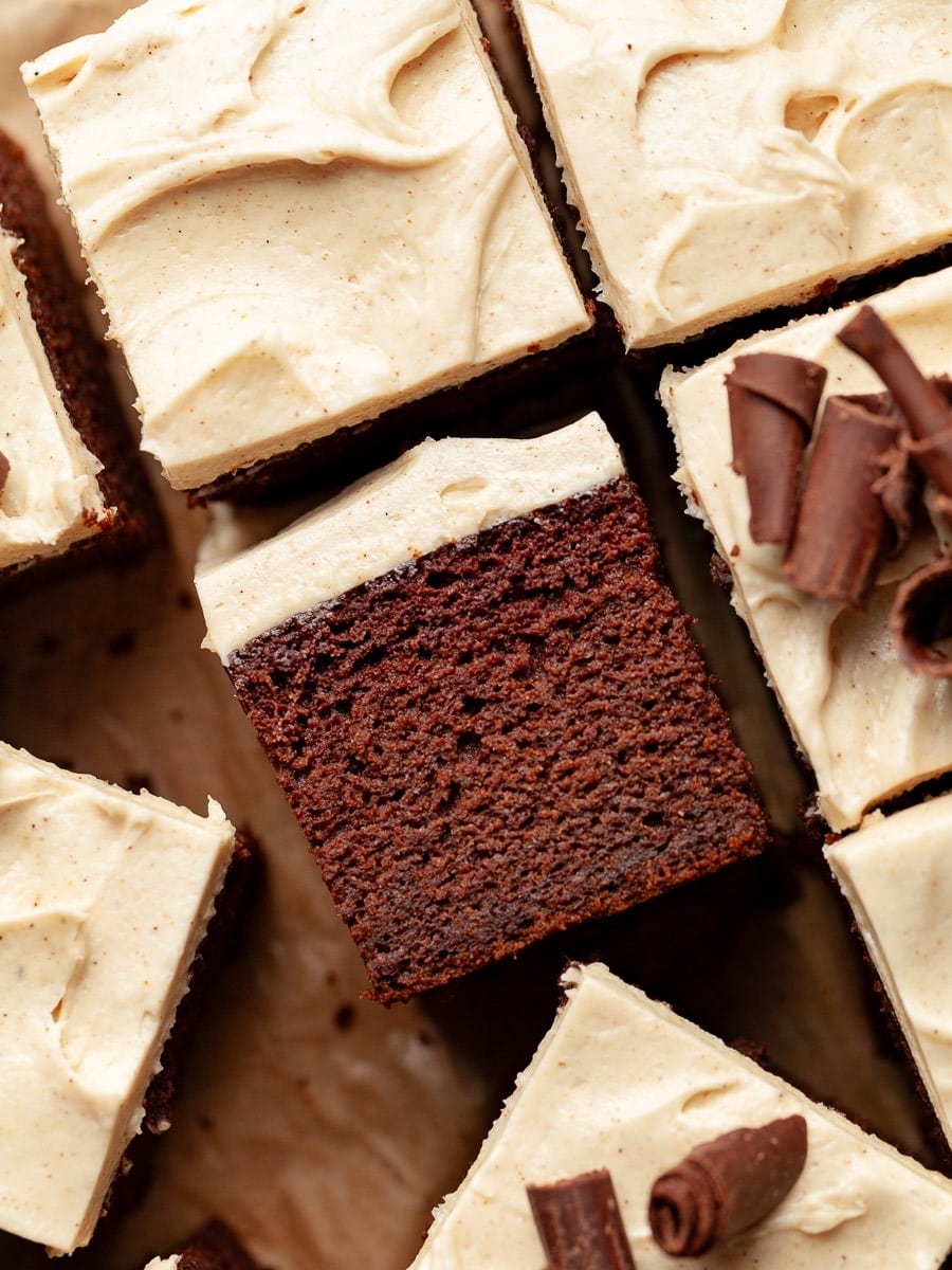 Gluten Free Spiced Chocolate Pumpkin Cake topped with spiced cream cheese frosting and chocolate curls