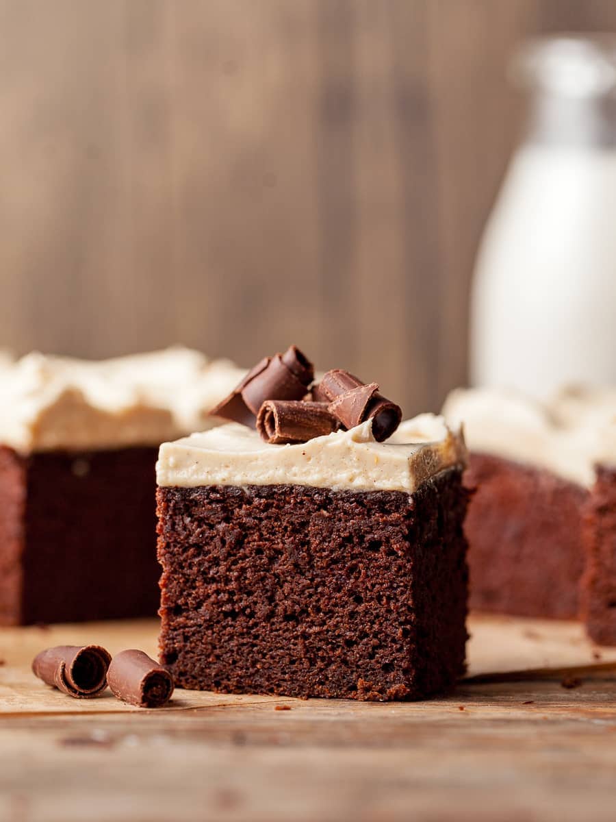 Gluten Free Spiced Chocolate Pumpkin Cake topped with spiced cream cheese frosting and chocolate curls