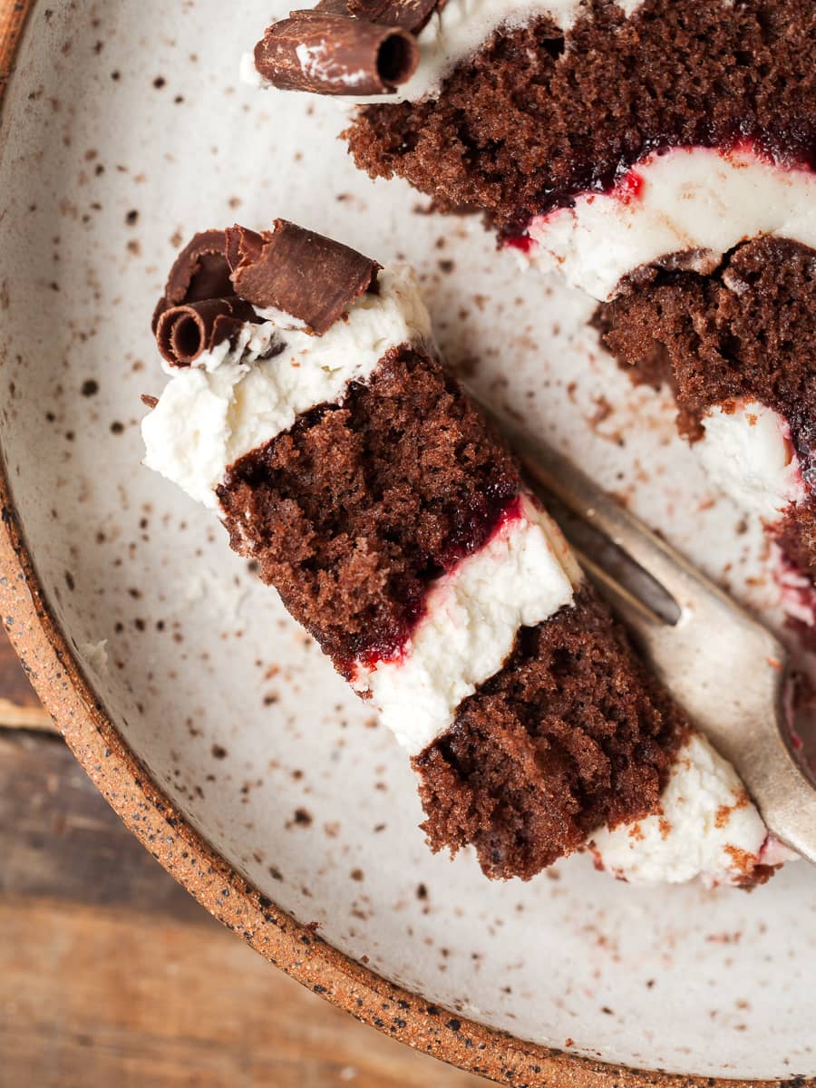 a piece of chocolate swiss roll on a fork, black forest swiss roll