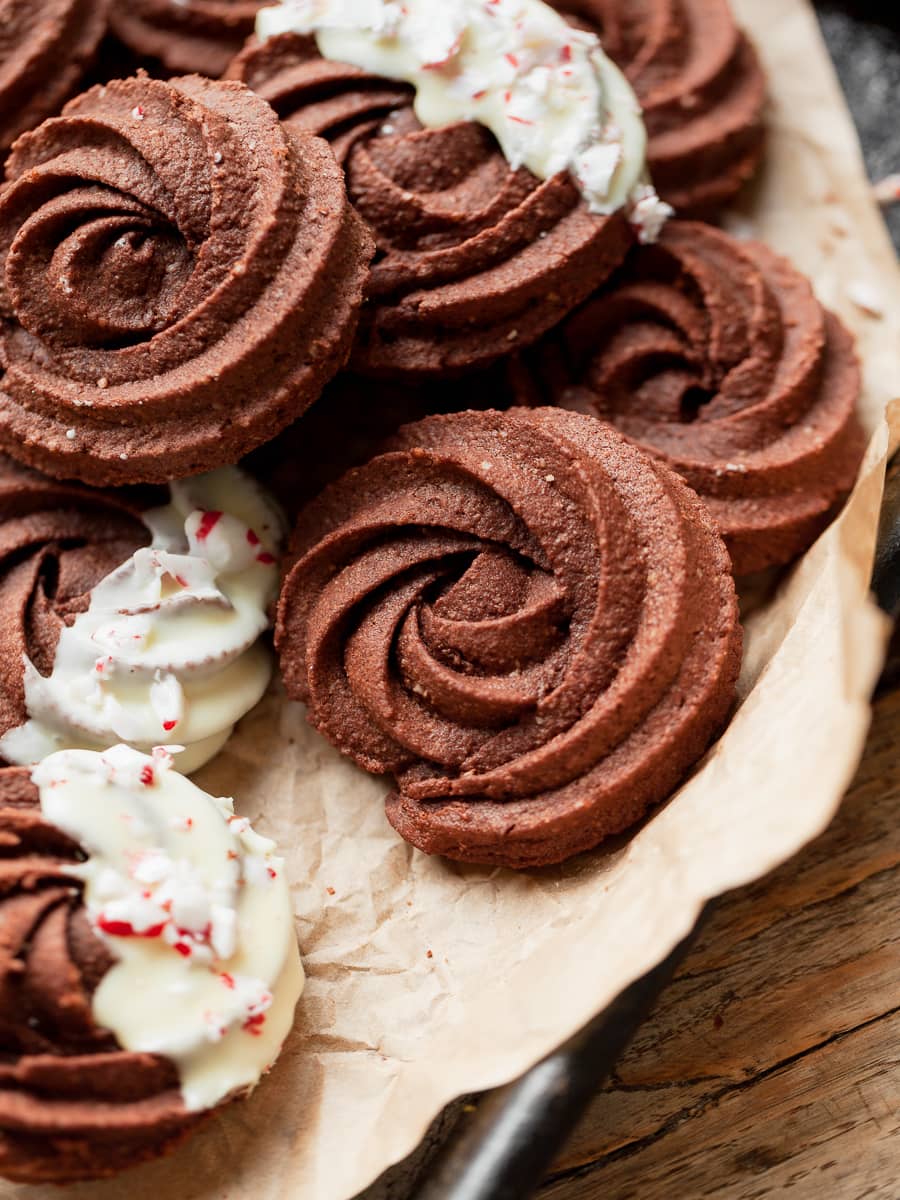 gluten free chocolate butter cookies, viennese cookies, chocolate whirls, on parchment paper