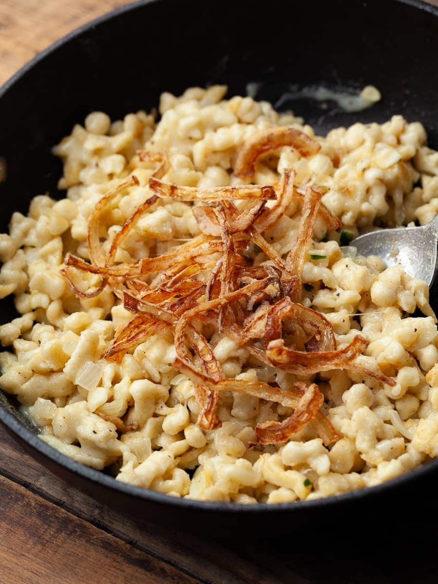 gluten free Kasspatzle topped with crispy onions in a skillet