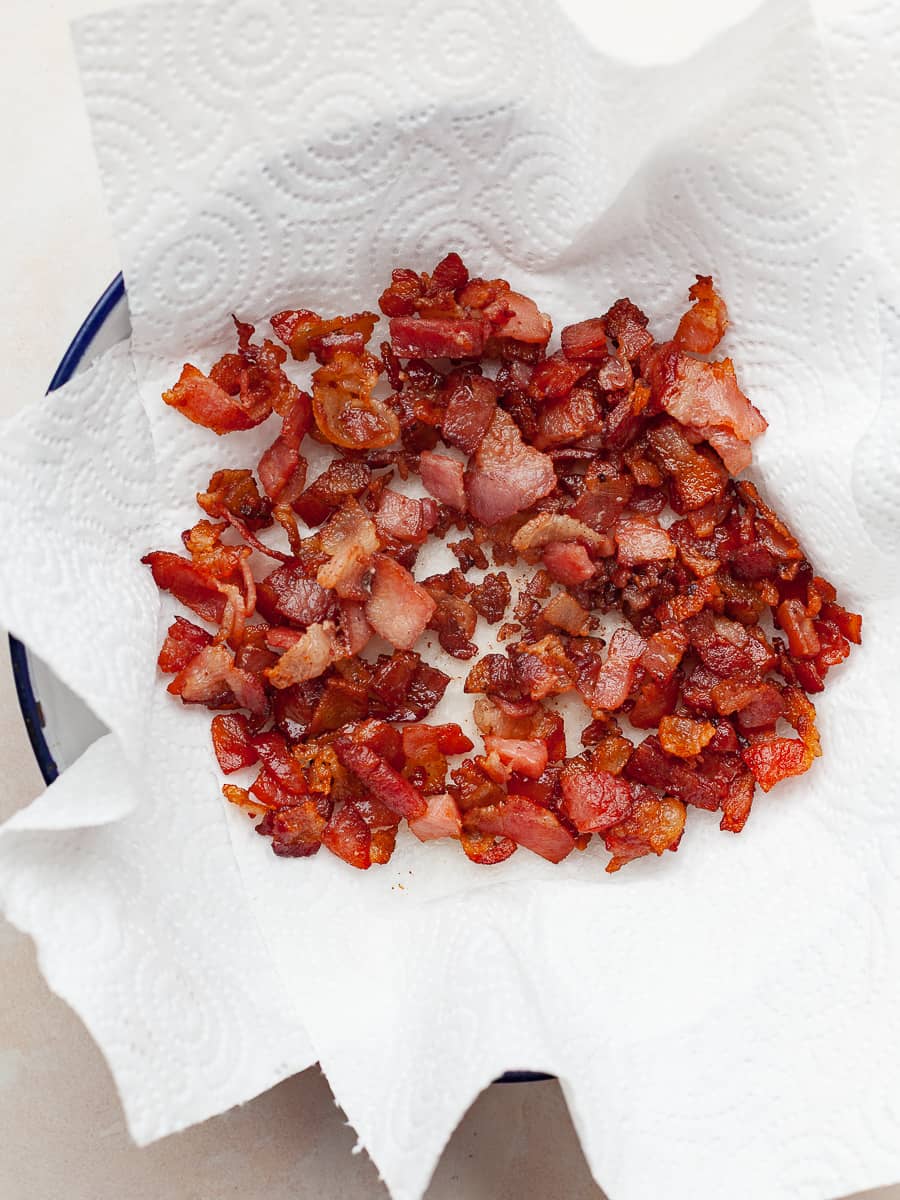 fried bacon on paper towels in a bowl