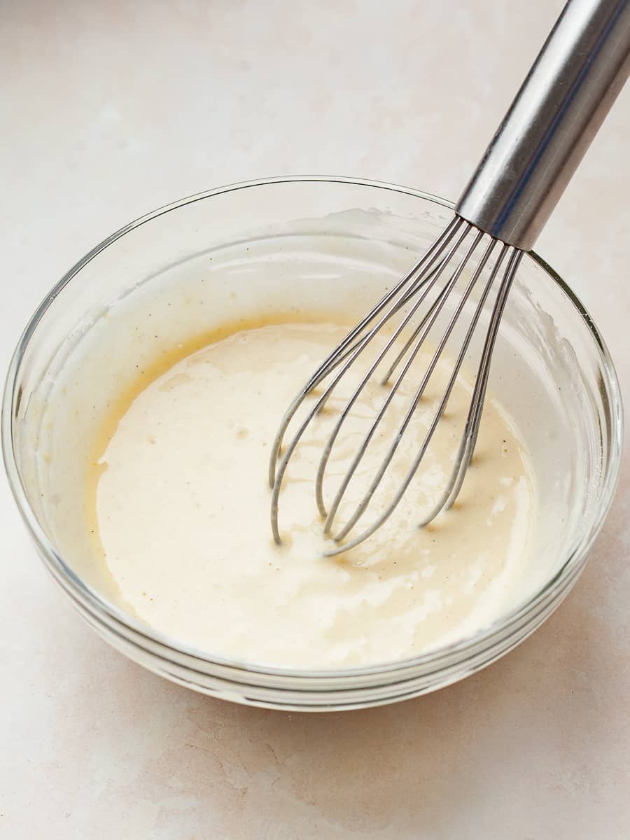 pancake batter for one in a mixing bowl with a whisk