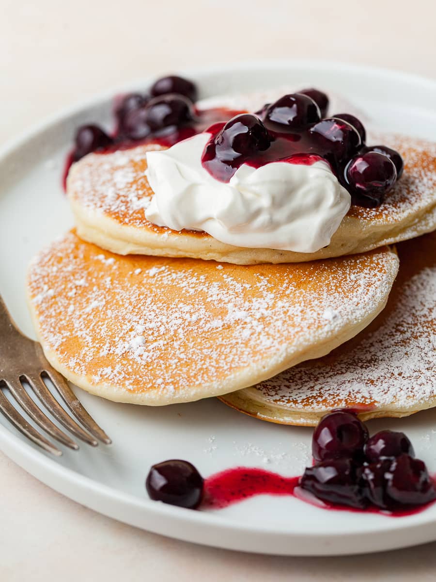 gluten free pancakes for one topped with sour cream and a simple blueberry sauce