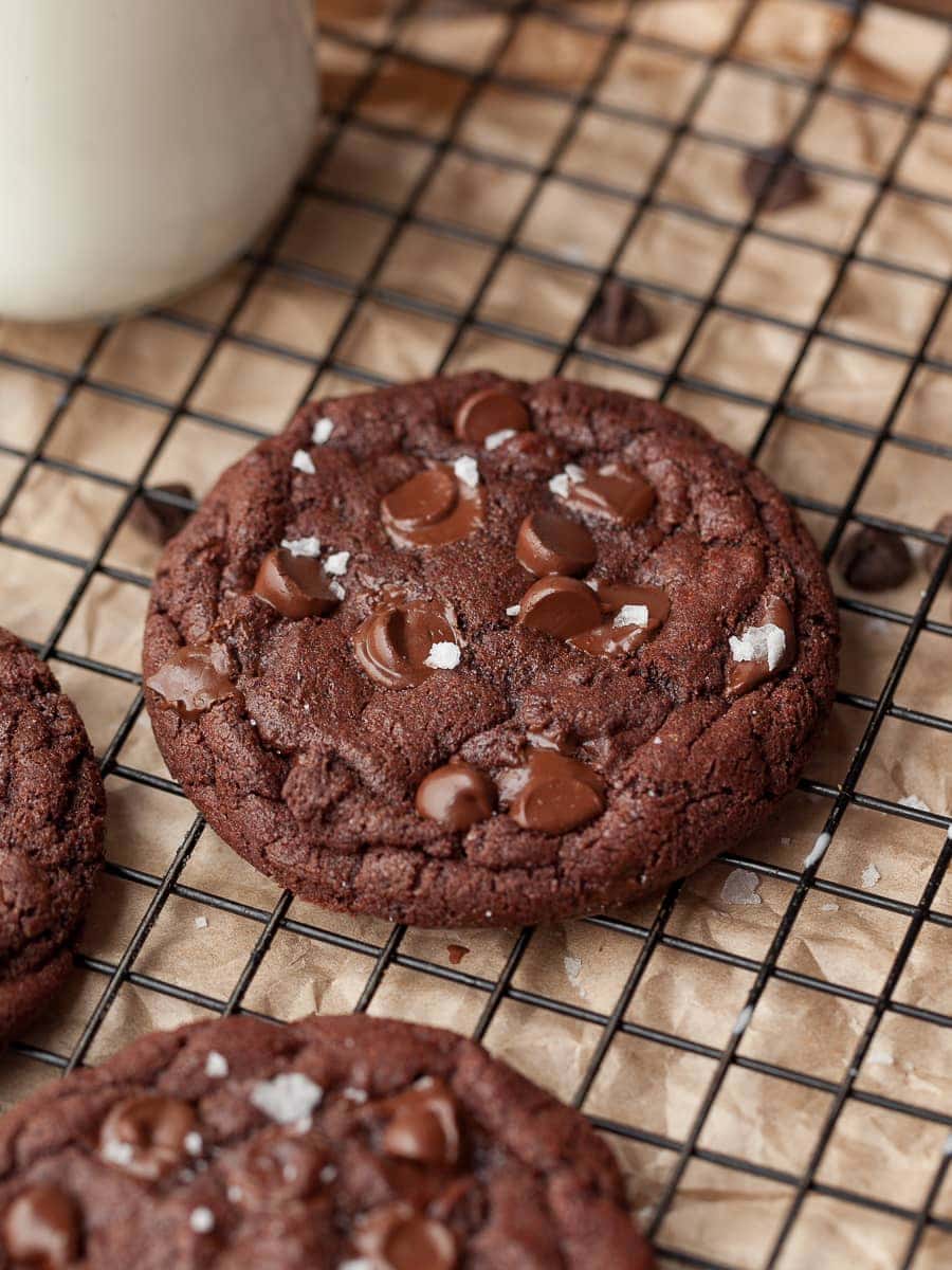 Gluten Free Small Batch Double Chocolate Cookies on a cooling rack, topped with flaky sea salt