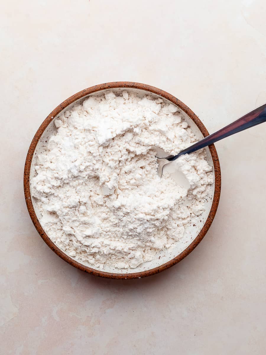 a bowl of gluten free flour, baking powder, baking soda and kosher salt combined together