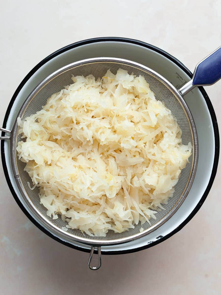 raw sauerkraut in a strainer