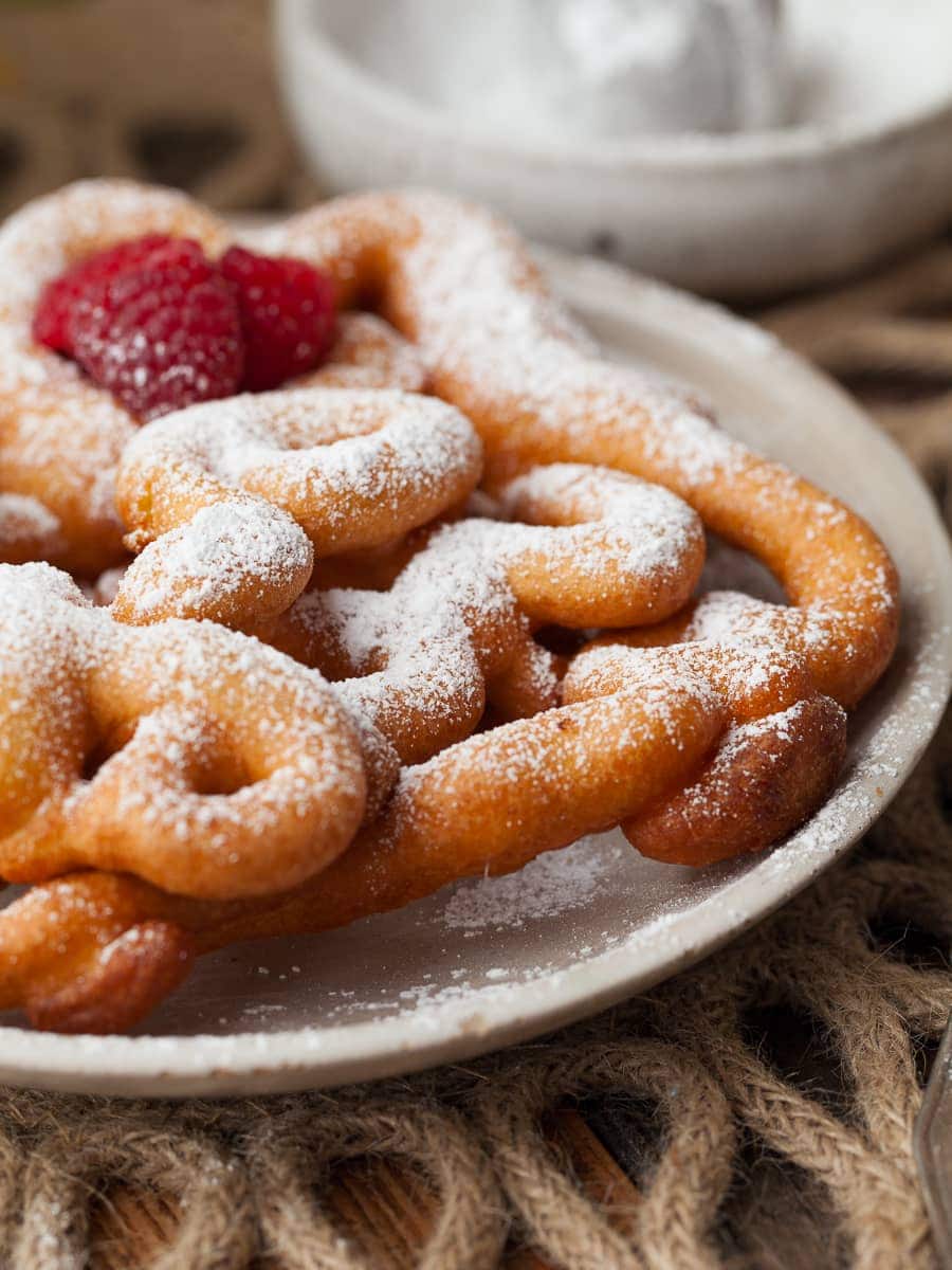 a gluten free strauben toppen with powdered sugar on a plate