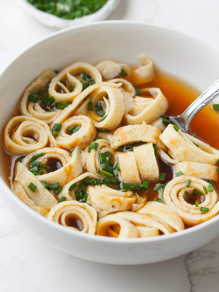 gluten free frittattensuppe in a bowl topped with fresh chives