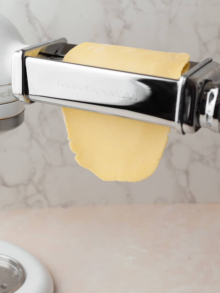 pasta dough in the kitchen aid pasta roller