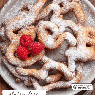 Golden, crispy, and delightfully lacy, Gluten Free Funnel Cakes - called Strauben in Austria - are the ultimate homemade treat and a festival favorite. Crisp on the outside and tender inside, these sweet spirals are perfect with powdered sugar, lingonberry jam, or whipped cream.