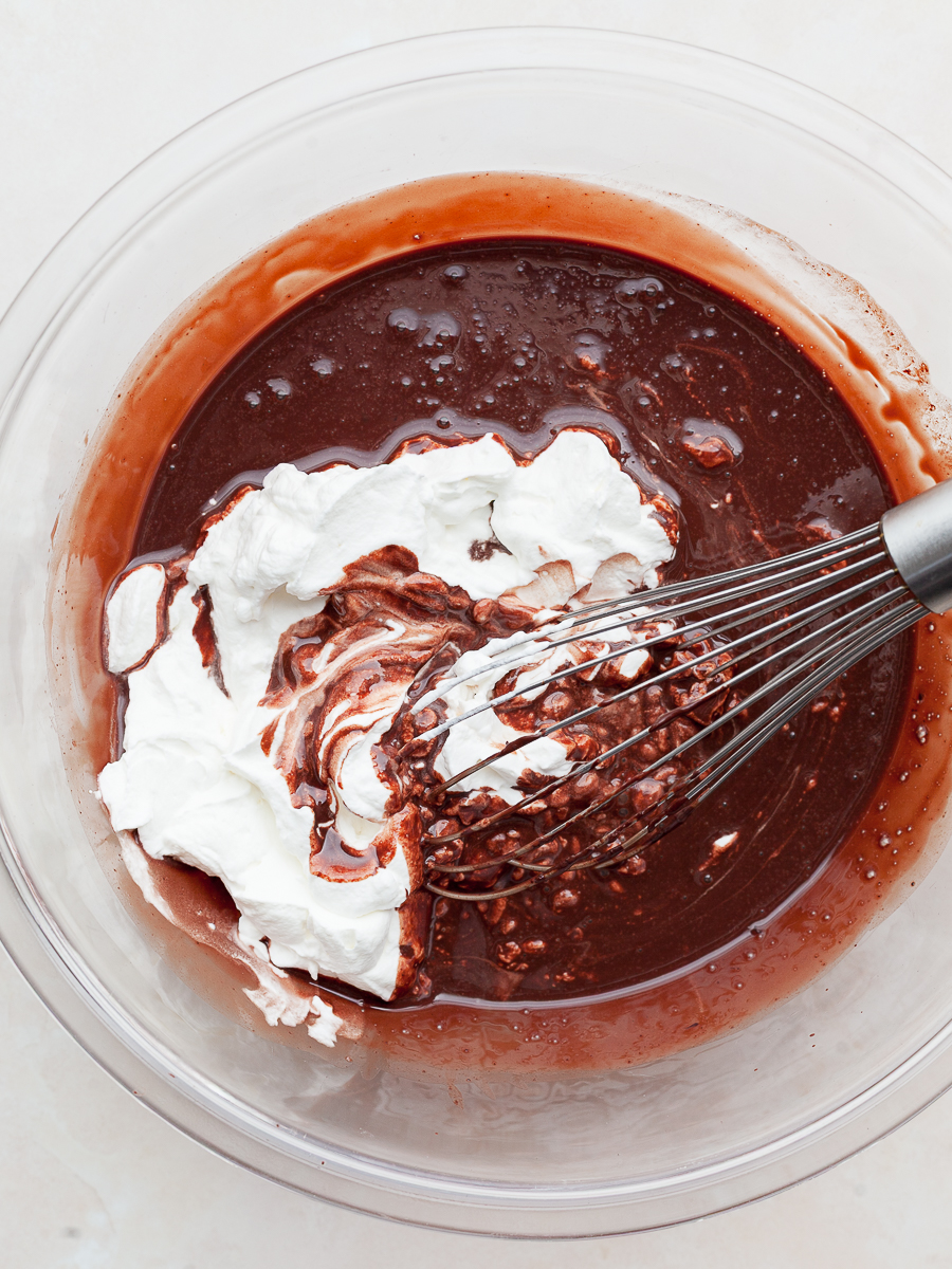 whipped cream being folded in chocolate no churn ice cream base