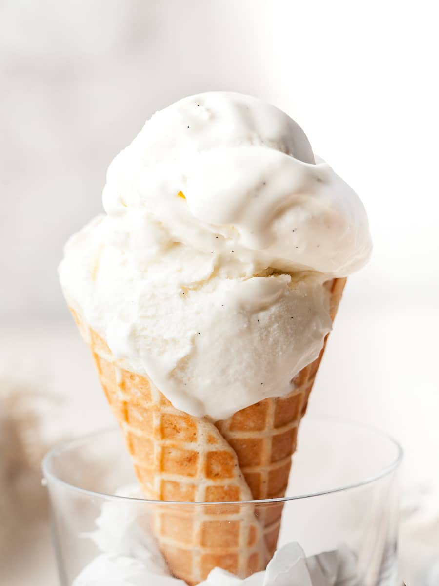 gluten free no churn vanilla ice cream on top of a gluten free waffle cone