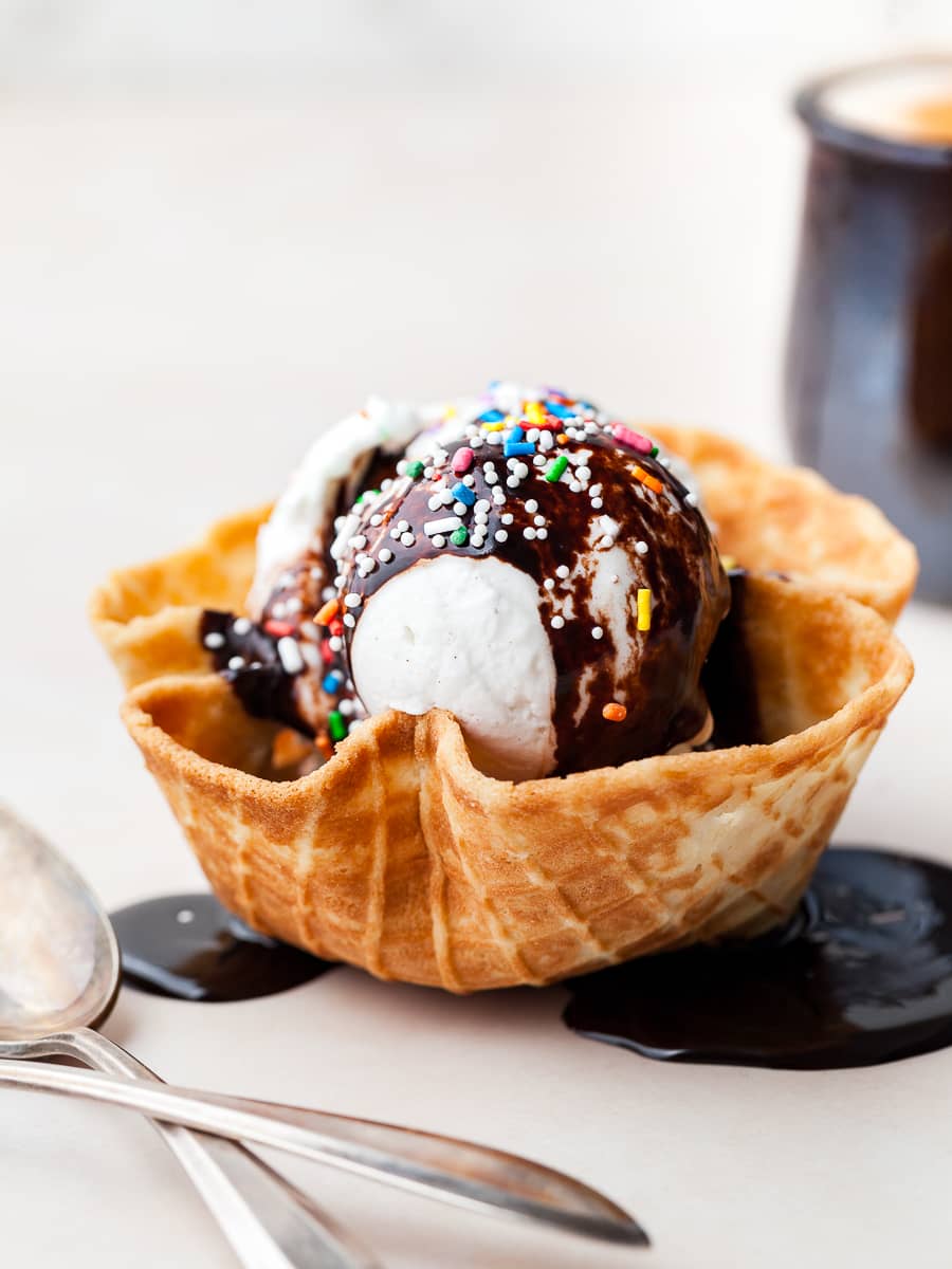 a gluten free waffle bowl with no churn vanilla ice cream, hot fudge sauce and sprinkles