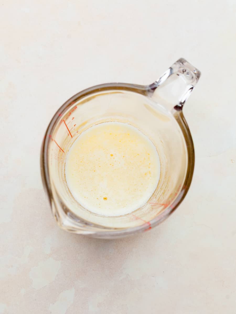 a small glass measuring cup with melted butter.