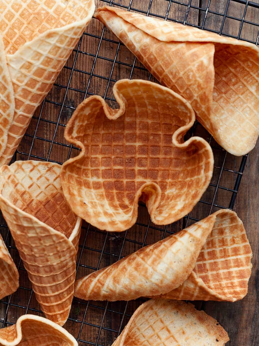 gluten free waffles and waffle bowl on a cooling rack