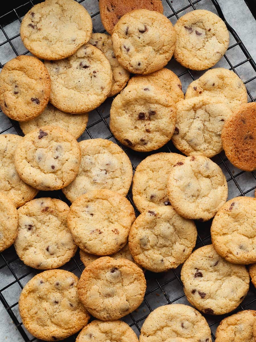 thin and crispy gluten free mini chocolate chip cookies on a cooling rack