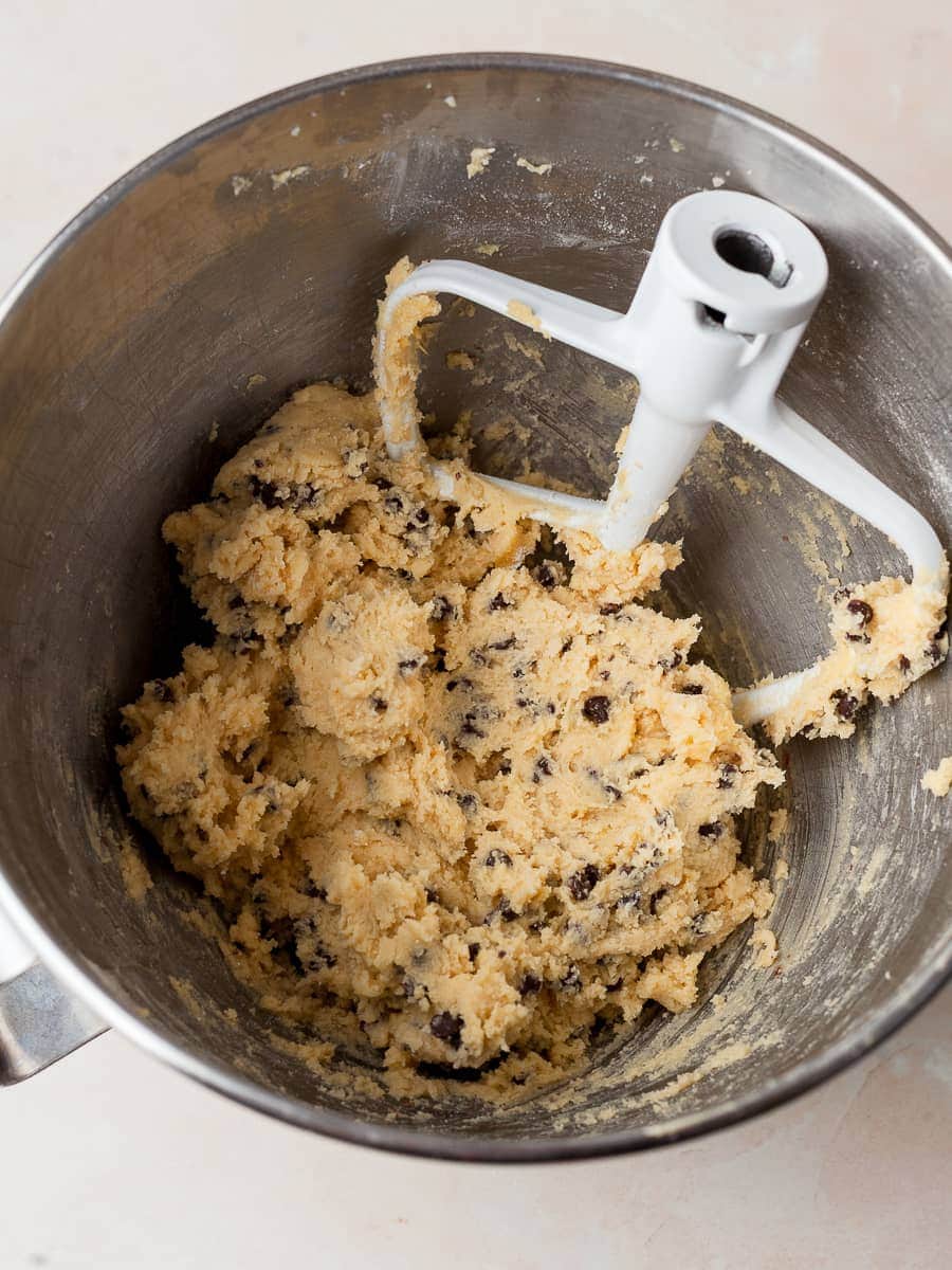 dough for mini chocolate chip cookies in a mixing bowl