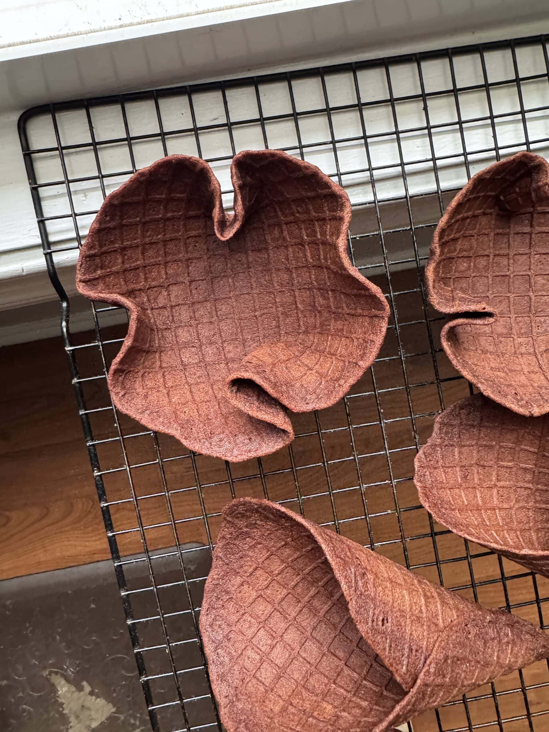 gluten free chocolate waffle cone bowls on a cooling rack